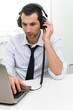 © Studio Gi - Businessman with laptop and headphones, selective focus