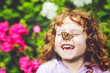 © ulkas - Laughing girl with a butterfly on his nose.