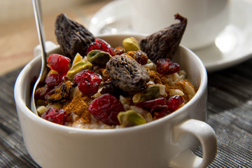 Wall Mural - coffee and oatmeal with fruit and nuts breakfast setting