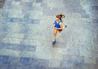 Young woman running in city center