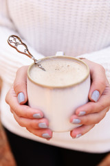 Woman holding cup of tasty hot drink, close-up,