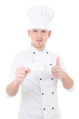 Wall Mural - young man chef  in uniform thumbs up and showing blank visiting