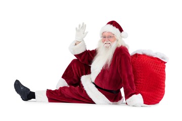 Poster - Santa sits leaned on his bag and waves