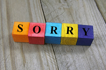 Wall Mural - concept of sorry word on wooden colorful cubes