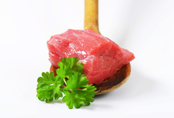 Canvas Print - Raw beef meat on wooden spoon