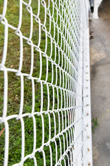 Wall Mural - Steel net fence with blur background