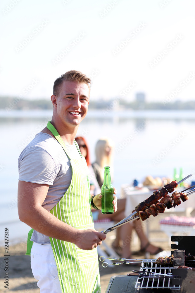 Young friends having barbecue party, outdoors