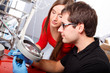 Scientists working with magnifier
