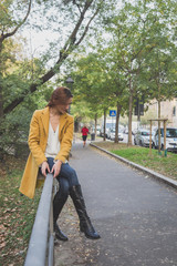 Wall Mural - Redhead girl posing in the city streets