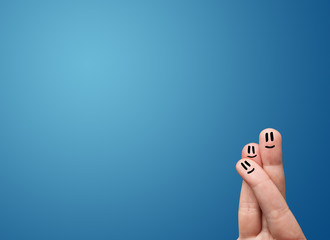 Happy smiley face fingers looking at empty blue background copy