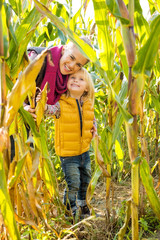 Wall Mural - Portrait of happy mother and child in cornfield