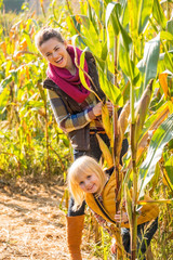 Wall Mural - Portrait of happy mother and child in cornfield