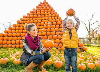 Wall Mural - Portrait of happy mother and child pumpkin 