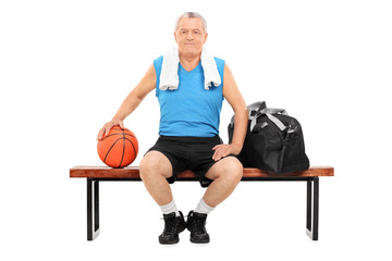 Poster - Mature man with basketball sitting on a bench