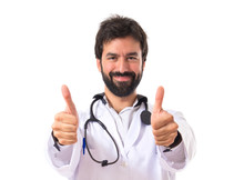 Doctor With Thumbs Up Over White Background