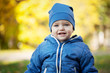 © Volha Zaitsava - Little smiling boy on the yellow background in the sunny autumn