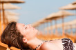 © nenadaksic - Young woman chilling on the beach