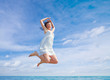 © nenadaksic - Woman Jumping In The Air On Tropical Beach