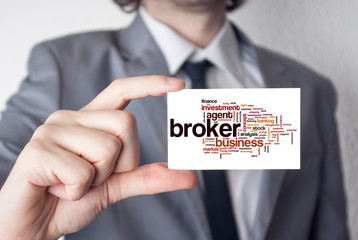 Sticker - Broker. Businessman in suit with a black tie showing business ca