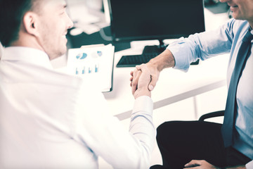 Wall Mural - businessmen shaking hands in office