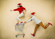 Christmas Couple With Trolley On Beige Background