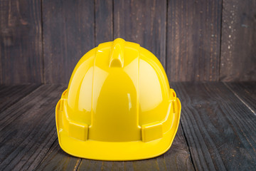 Wall Mural - Construction hard hat on wooden background