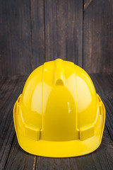 Wall Mural - Construction hard hat on wooden background