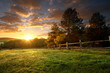 Leinwandbild Motiv Picturesque landscape, fenced ranch at sunrise