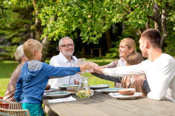 Wall Mural - happy family having holiday dinner outdoors