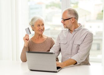 Wall Mural - happy senior couple with laptop and credit card