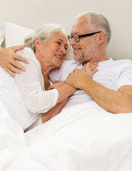 Canvas Print - happy senior coupler lying in bad at home