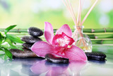 Fototapeta  - Spa stones, sticks, bamboo branches and lilac orchid