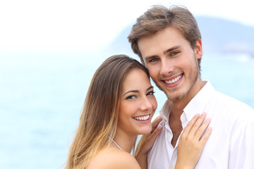 Happy couple with a white smile looking at camera