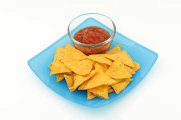 Tortilla chips with salsa sauce in dish on white background