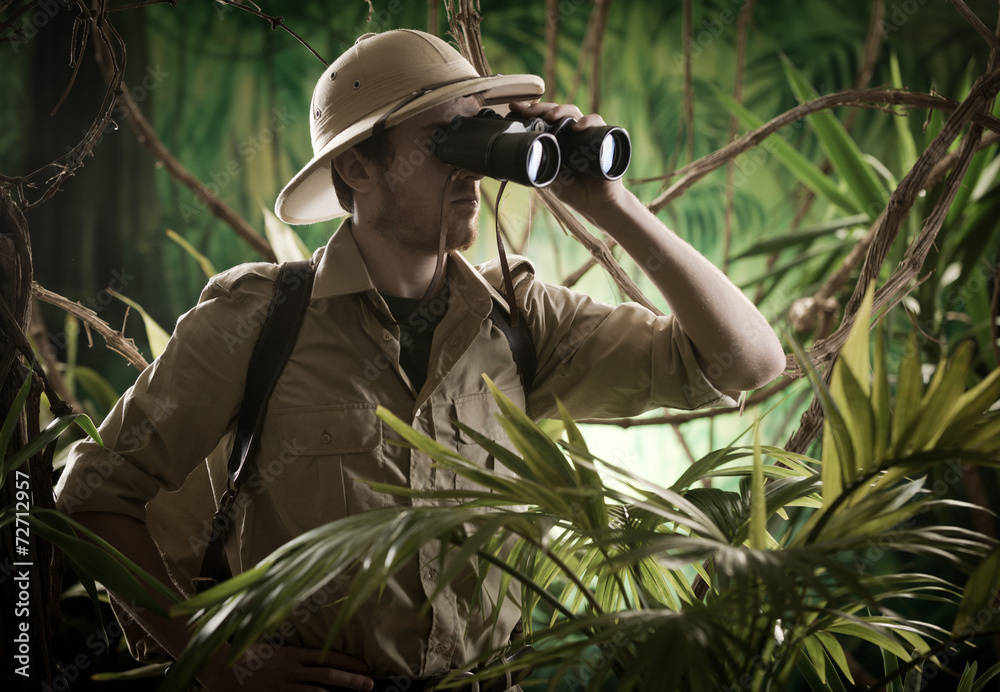 Explorer in the jungle with binoculars - obrazy, fototapety, plakaty 