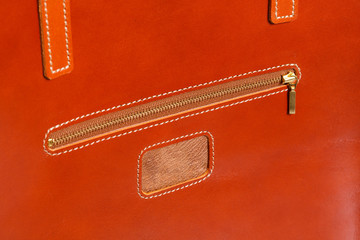 Closeup of brown leather briefcase with brass buckle