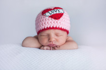 Newborn Baby Girl Wearing A "Love" Hat
