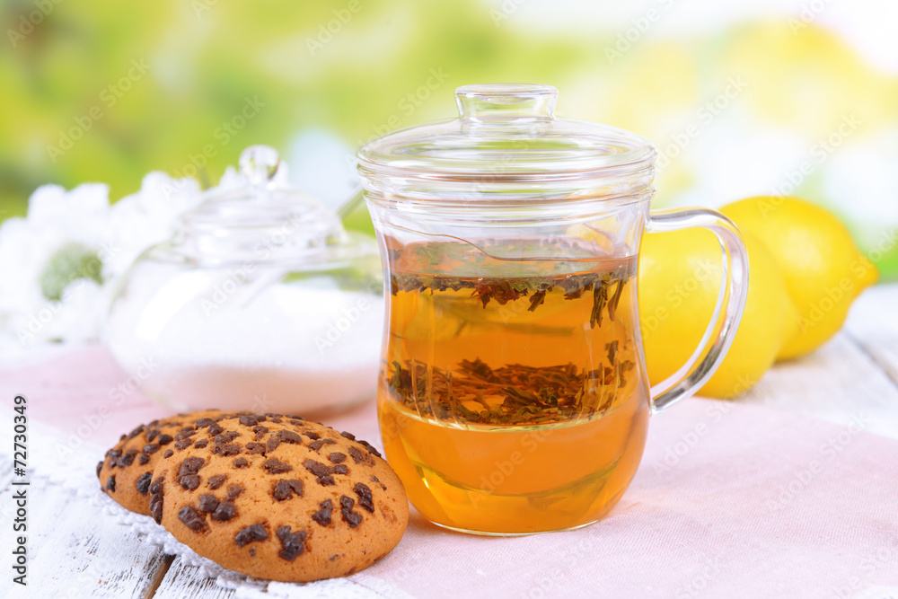 Cup of tea on table on bright background
