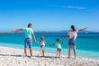 © travnikovstudio - Young beautiful family with two kids on tropical vacation