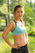 © DragonImages - Portrait of fit Vietnamese girl wearing sports bra