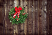 Christmas Wreath Against Rustic Wooden Background