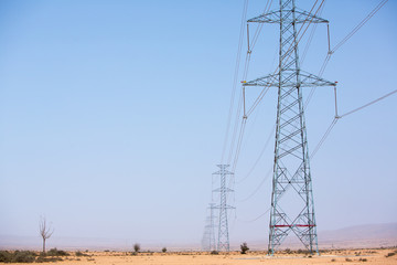 Electrical towers across the desert near Tata, Morocco