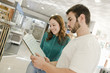 © FotoAndalucia - Couple looking tiled bathroom at store
