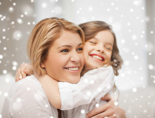 Wall Mural - happy mother and daughter hugging at home