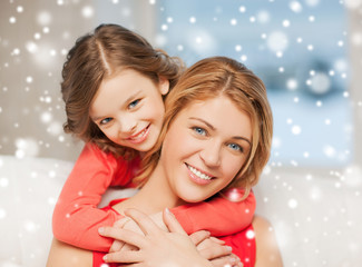 Canvas Print - happy mother and daughter hugging at home