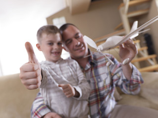 father and son assembling airplane toy