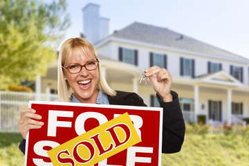 Wall Mural - Excited Woman Holding House Keys and Sold Real Estate Sign