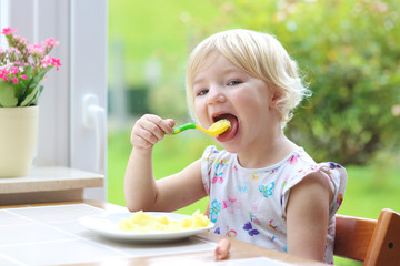 Little girl eating mashed potato for lunch