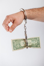 Hand Handcuffed To A One Dollar Banknote