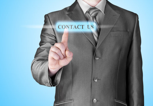 Businessman pushing CONTACT US sign
